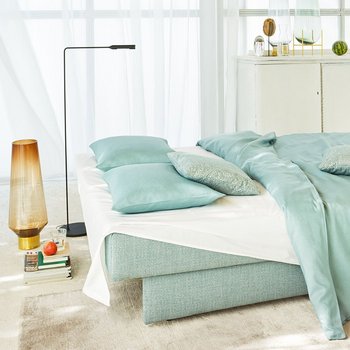 JOKA Perla Doppelliege in Mintgrün, zu einem Bett mit Bettwäsche und Kissen ausgeklappt.