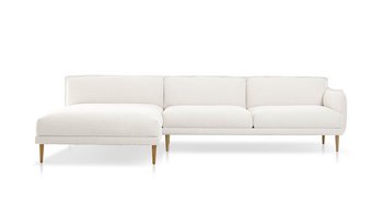 Freigestellte Frontalansicht einer großzügigen weißen Bouclé-Eckcouch mit Chaiselongue.
